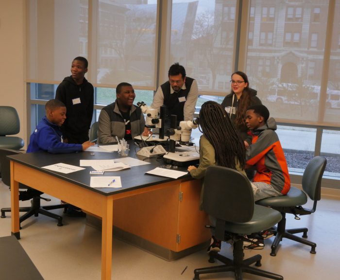 HS teacher with a group of HS students at a lab table